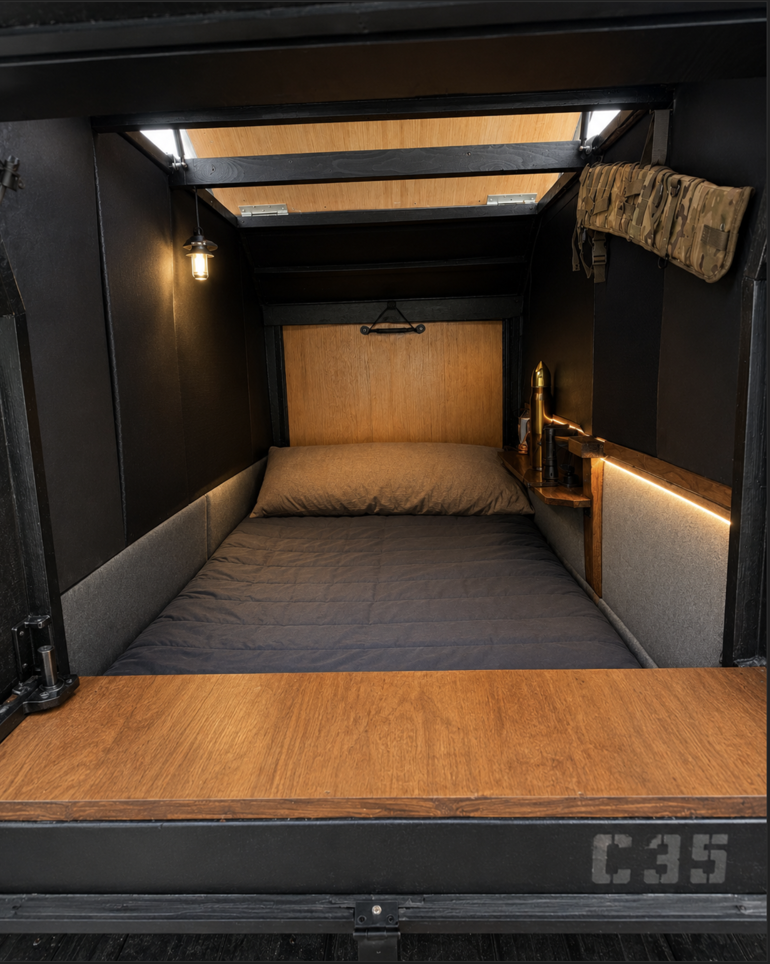 Bro Pod C35 insulated interior hunter style micro camper sleeping space with compact wood floor and lighting
