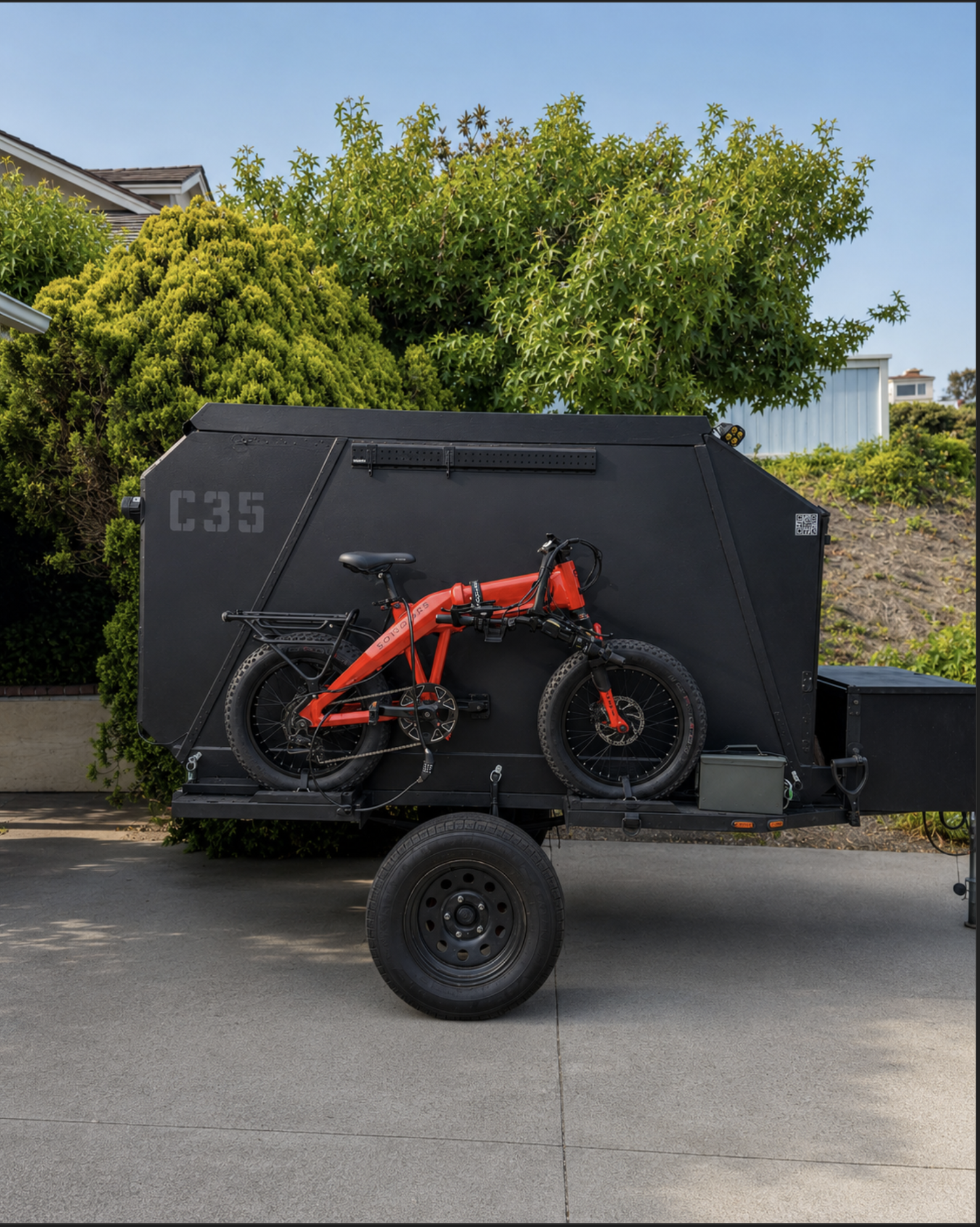 Real Bro Pod C35 DIY camper pod build in driveway with e-bike mounted on side